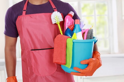 Carpet cleaning technician with safety equipment in a home